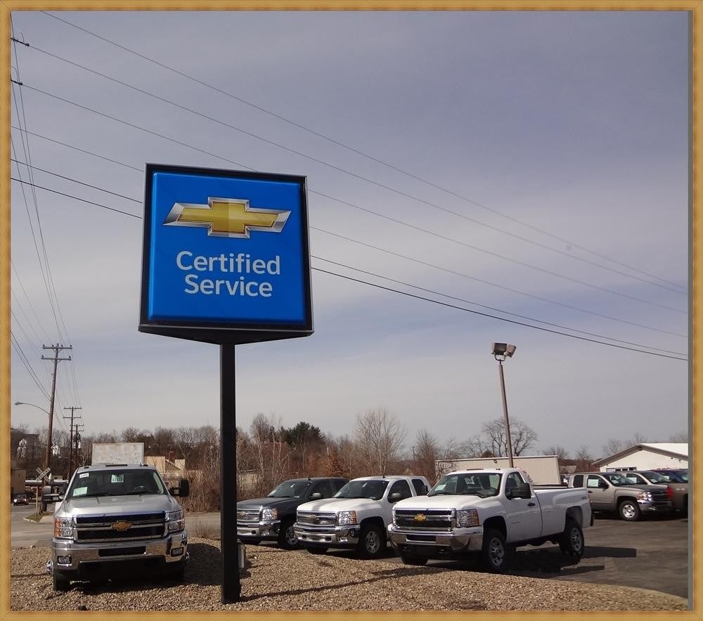 Certified service center hording with cars parked near hording